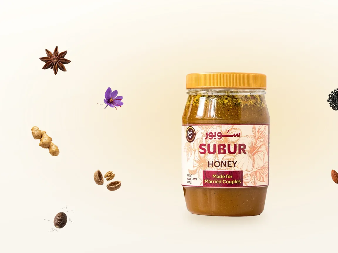 Star anise, saffron, ginger and coffee beans arranged around a jar of SUBUR honey.