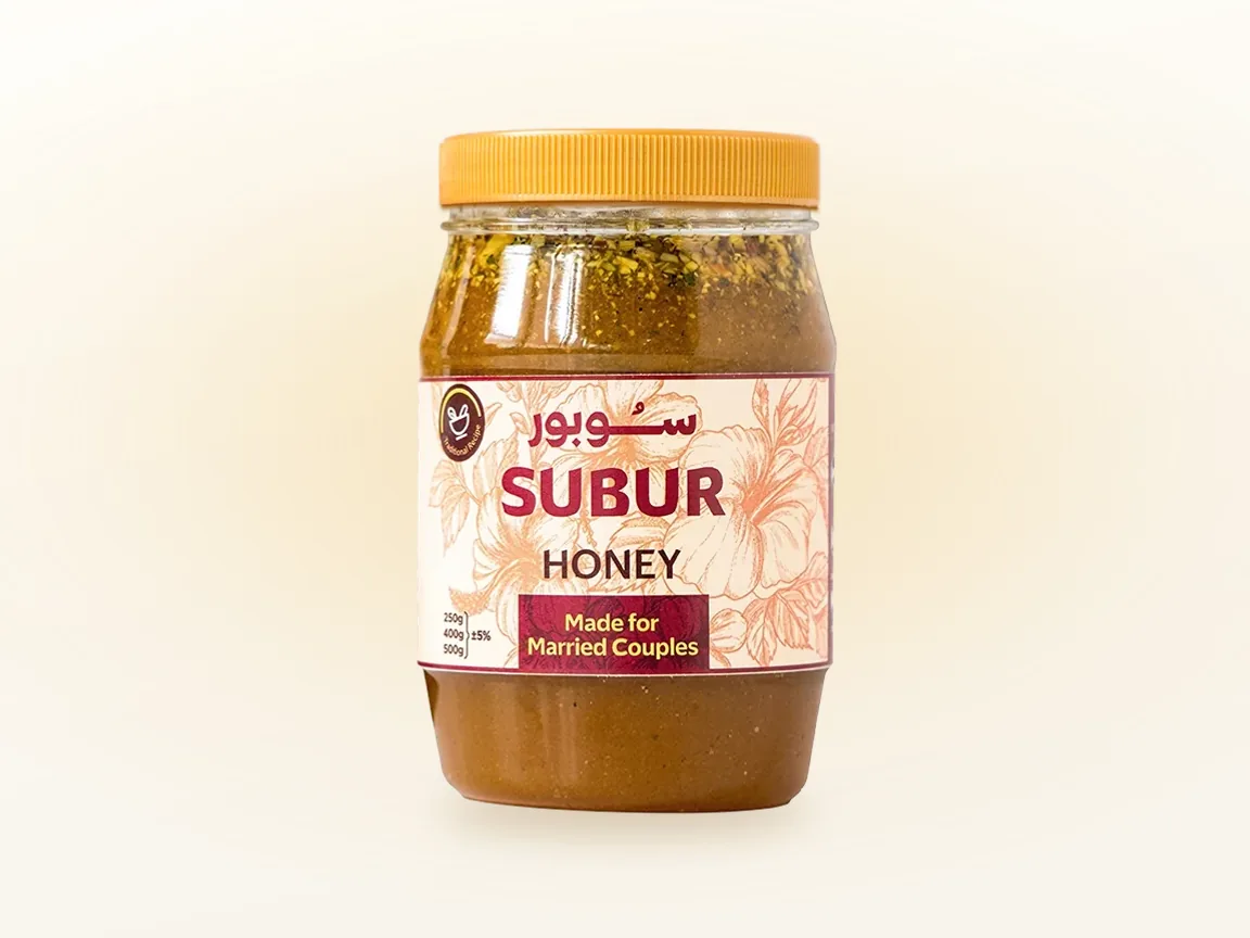 A jar of SUBUR honey standing alone against a plain cream background.